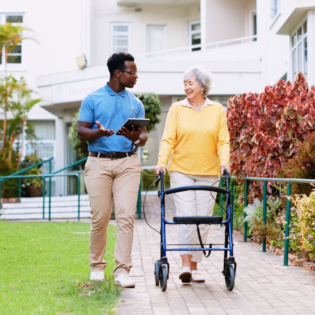 Caregiver assisting senior outdoors